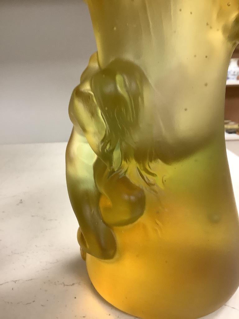 An amber vase with a nude study in relief, apocryphal Daum mark, 24cm high